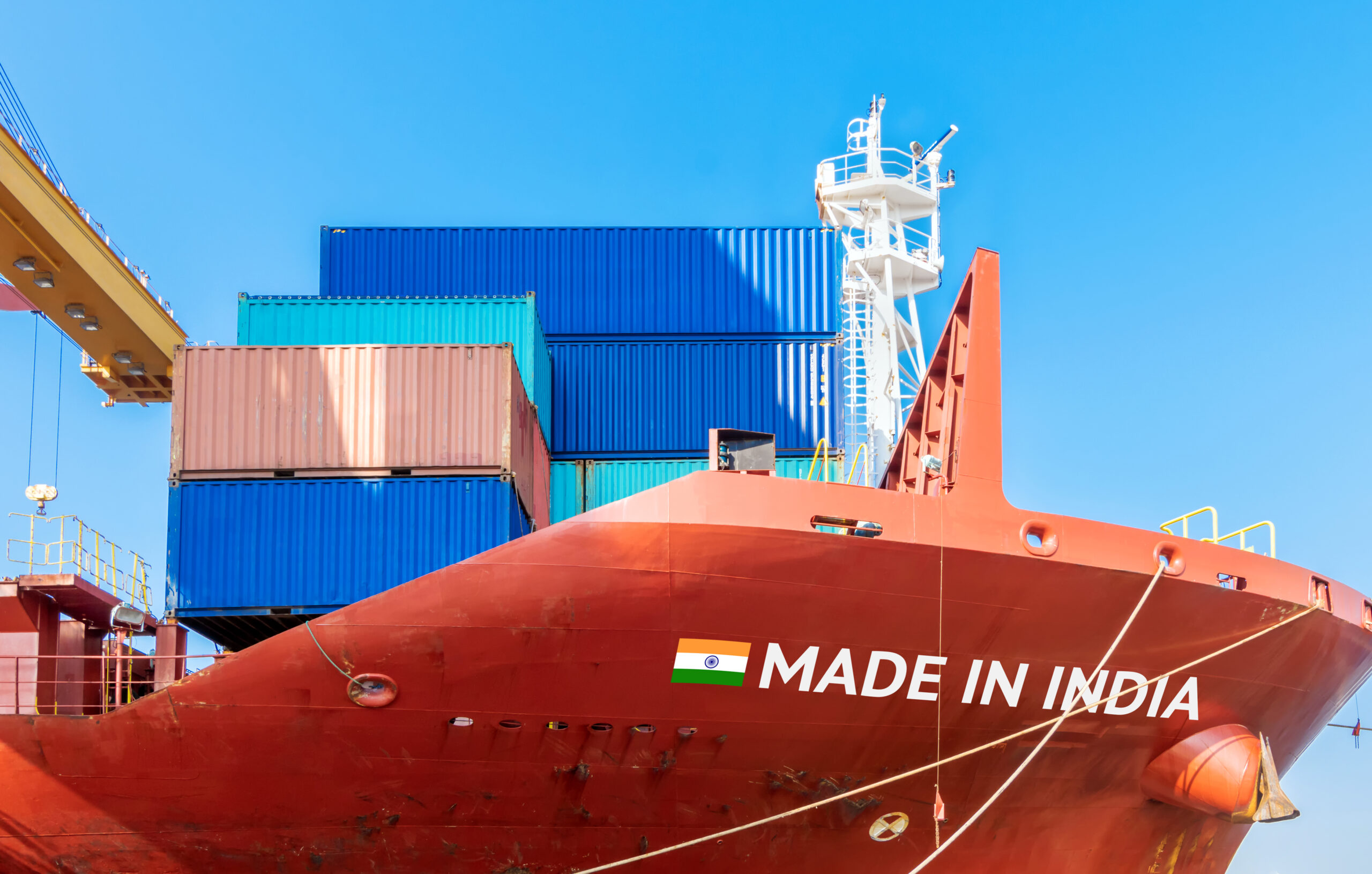 A large red freighter ship that says Made in India on it.