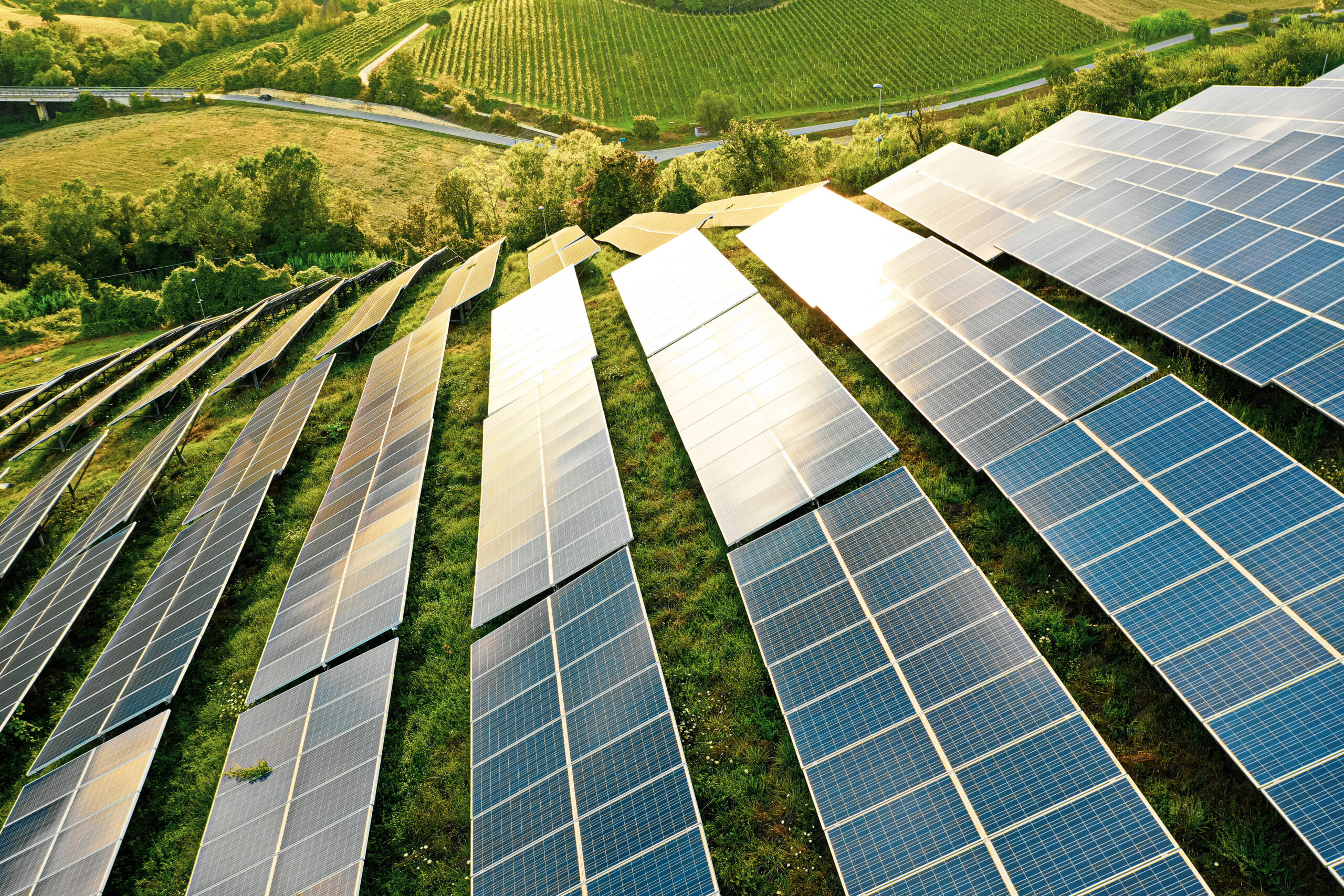 Solar panels fields on the green hills.