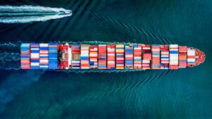 Top view of a large shipping freighter moving in the ocean.