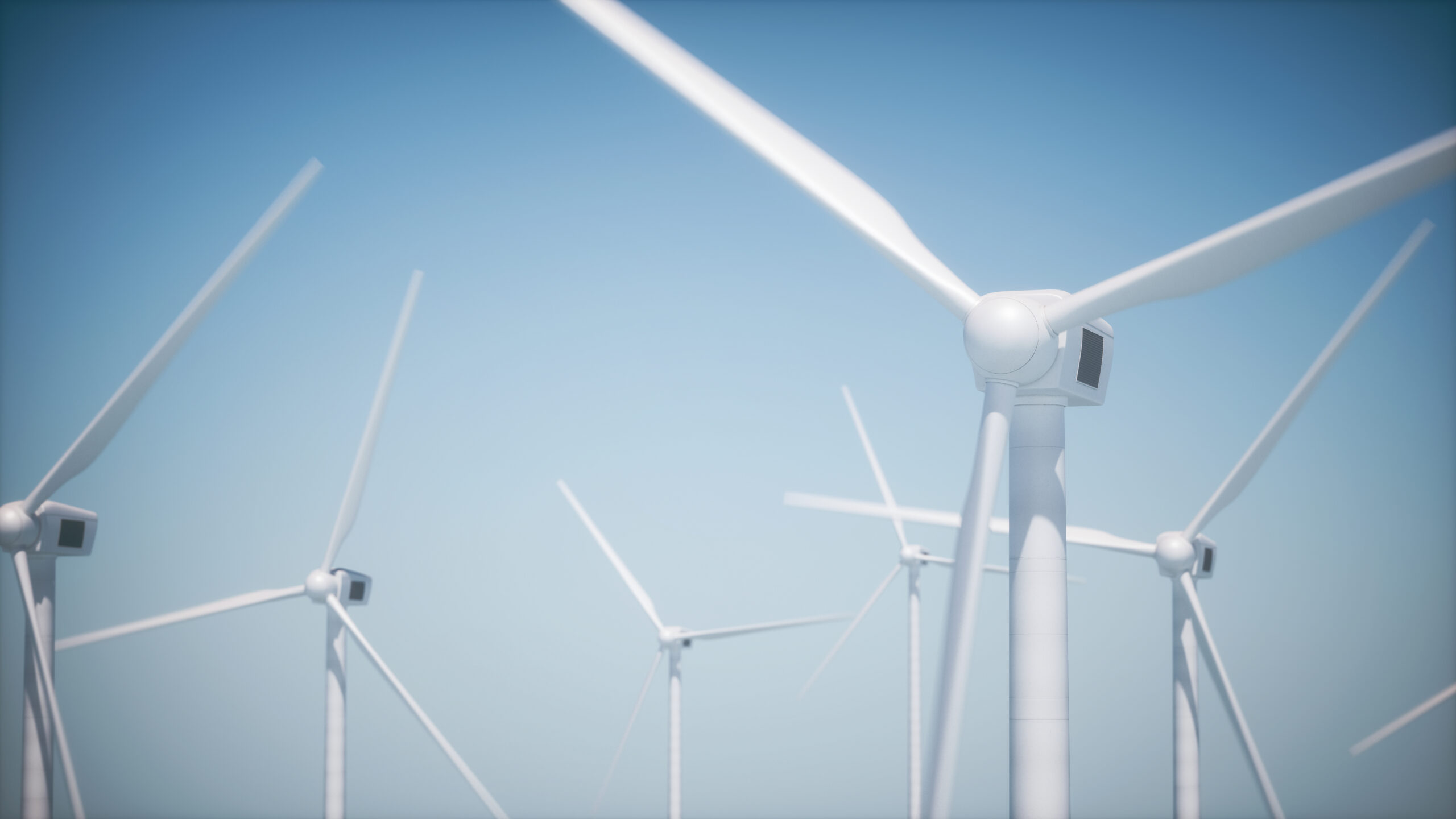 Windmills moving against a blue sky.