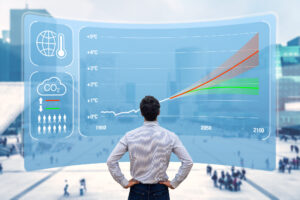 A man standing facing a large illustrated screen with an emissions graph.